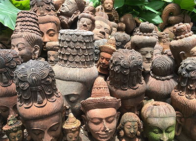 Image of various Buddha heads piled in a mound